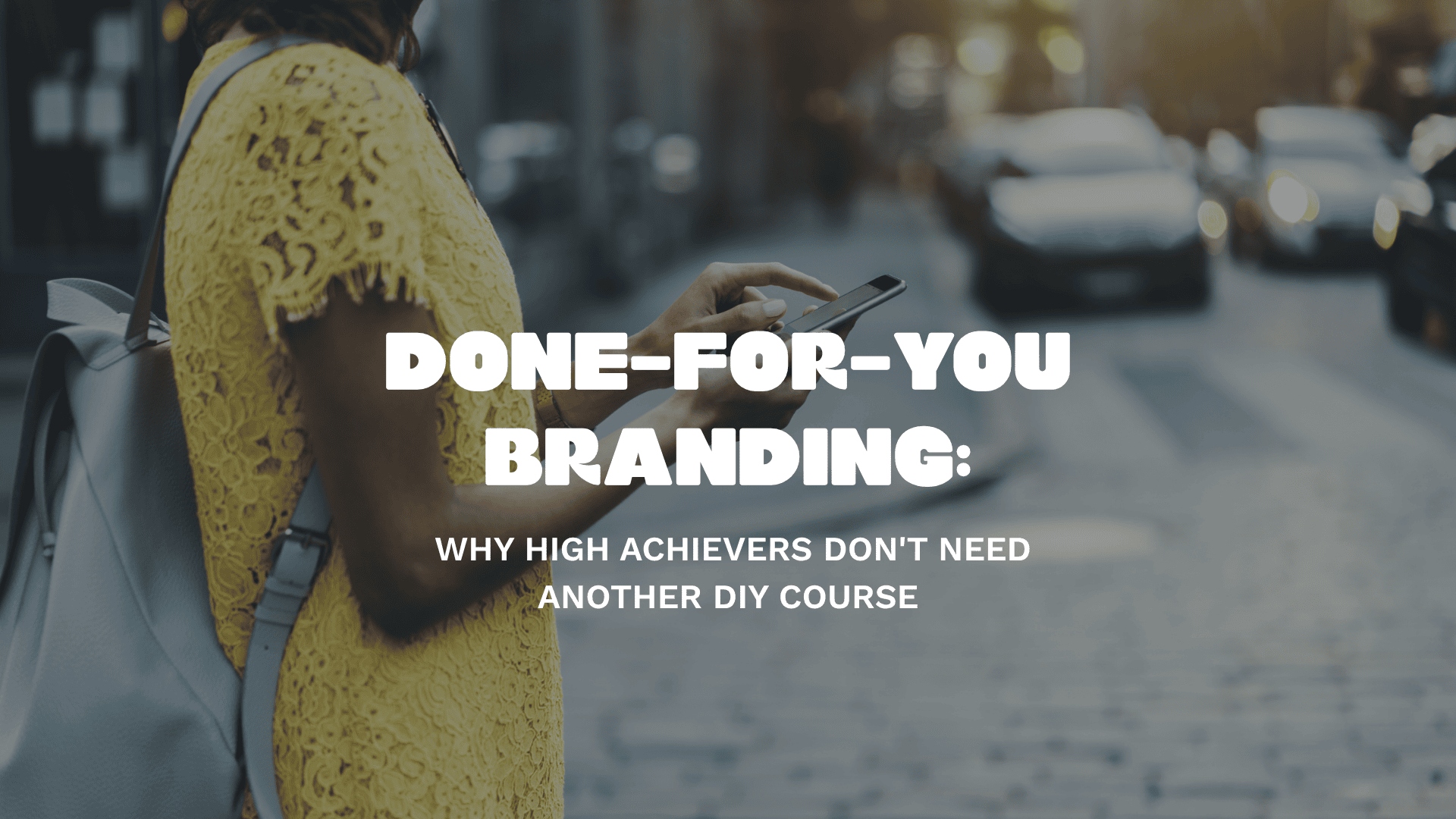 Woman in a yellow dress checking her phone on a city street — done-for-you branding for entrepreneurs who are too busy building a business to DIY